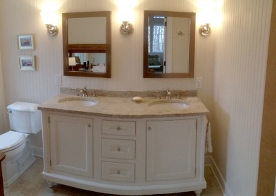 Wainscoting bathroom renovation with cabinetry and vanity